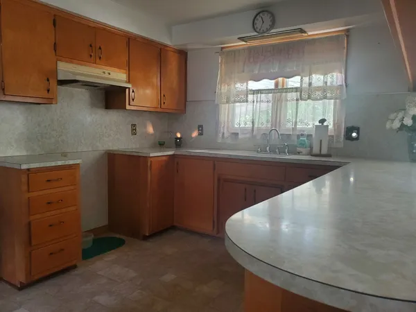 a kitchen with cabinets a sink and appliances