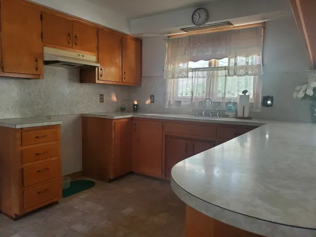 a kitchen with cabinets a sink and appliances