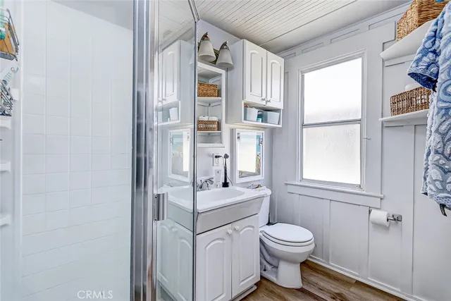 a bathroom with a toilet sink a shower and a window