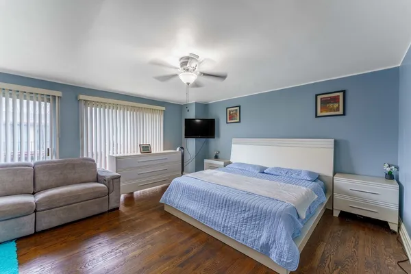 a spacious bedroom with a bed and a couch