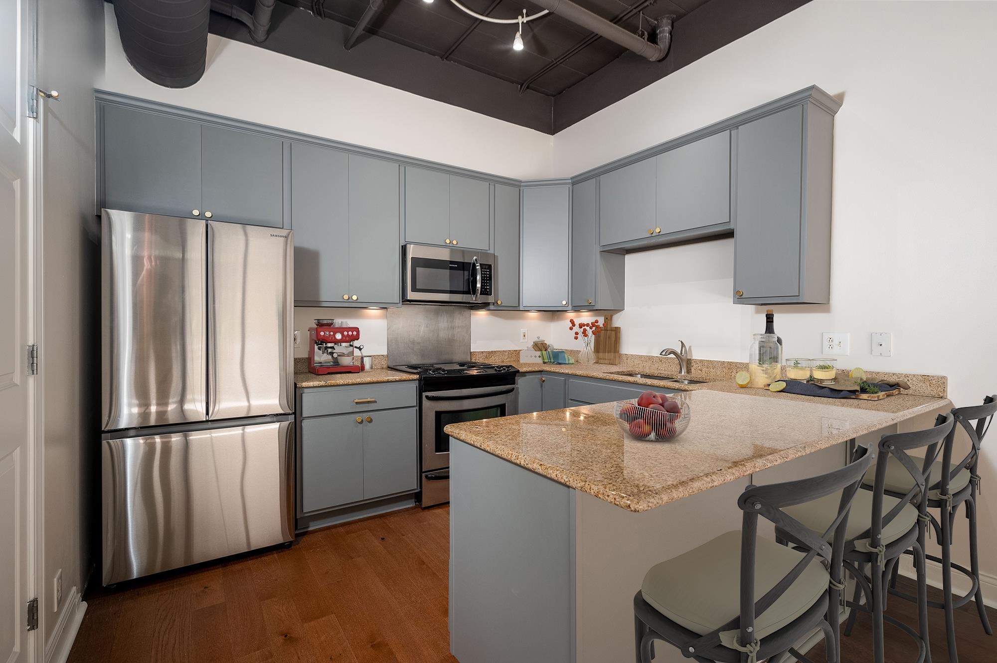 95 South Main Street, Unit 204 Memphis, TN 38103 - Photo 10 of 18 a kitchen with a sink a stove a refrigerator and chairs