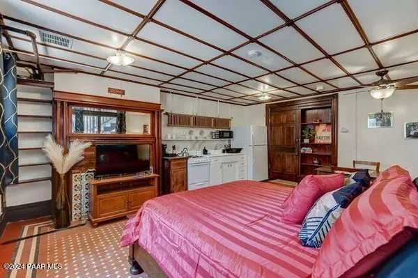 a bedroom with a bed and a chandelier