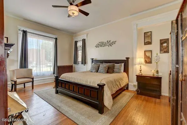 a spacious bedroom with a bed and chair