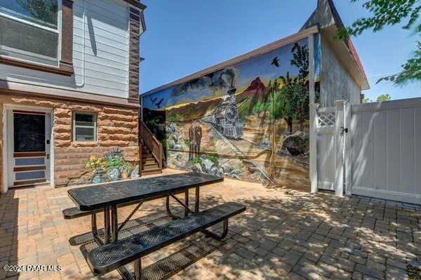 a backyard of a house with barbeque oven