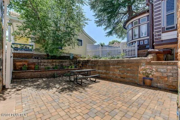 a front view of a building with a garden