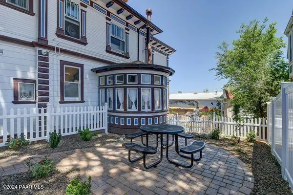 a view of a house with wooden deck and furniture