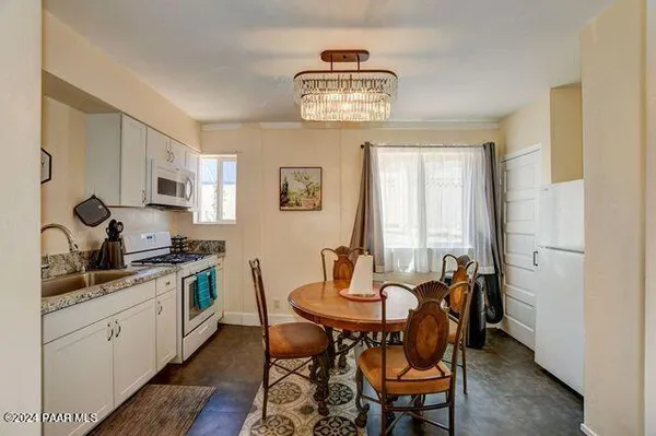 a view of a dining room with furniture and chandelier