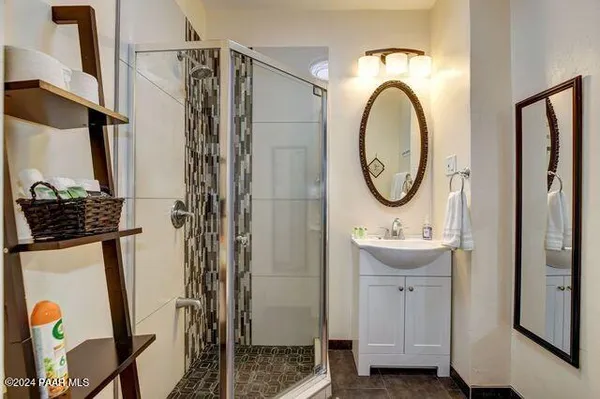a bathroom with a sink a mirror and a shower
