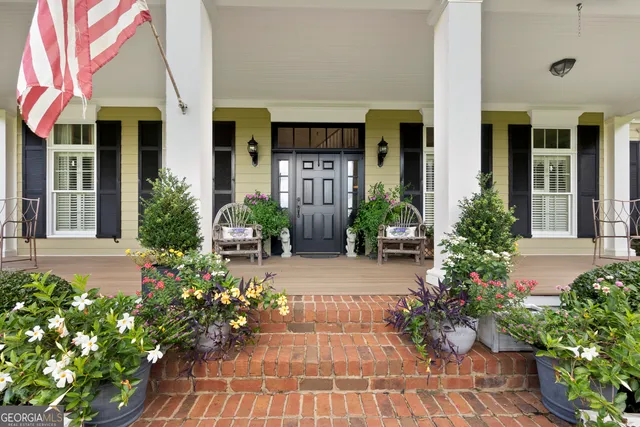 a living room with furniture a fireplace and a large window