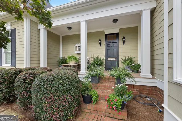 a living room with fireplace furniture and a floor to ceiling window