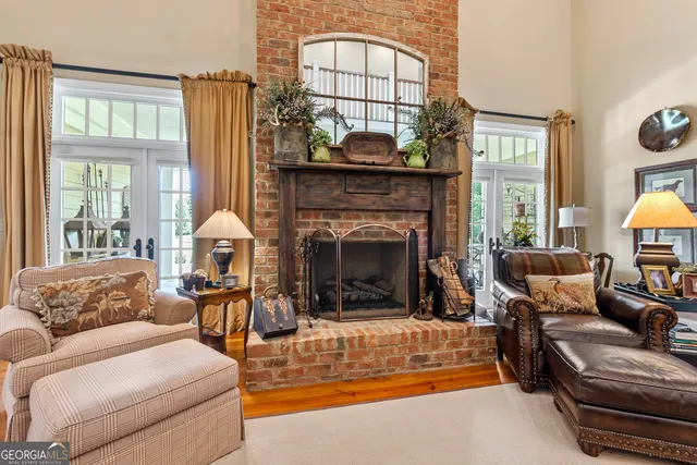 a kitchen with stainless steel appliances kitchen island granite countertop a stove top oven a sink dishwasher a dining table and chairs with wooden floor