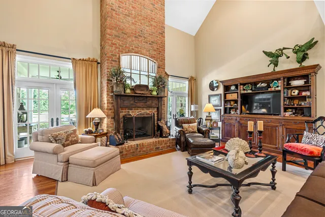 a dining room with furniture a chandelier and wooden floor