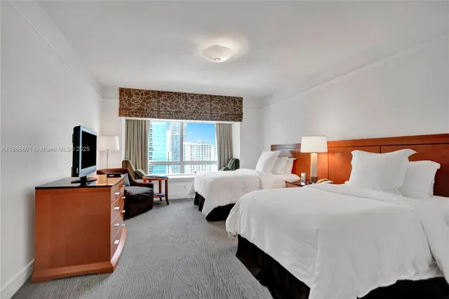 a bed room with bed and a tv