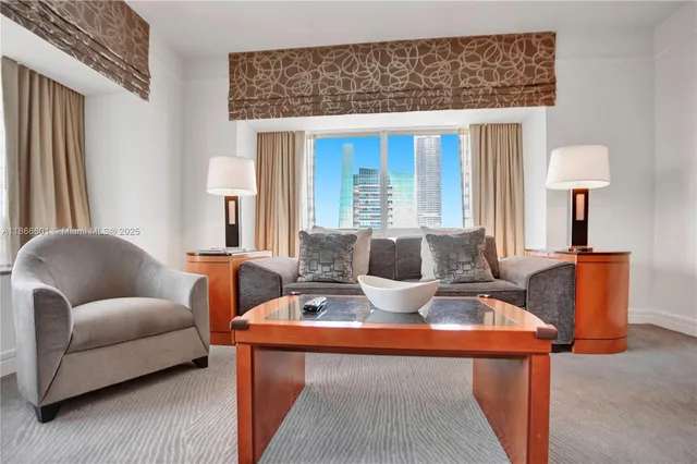 a living room with furniture a lamp and a potted plant