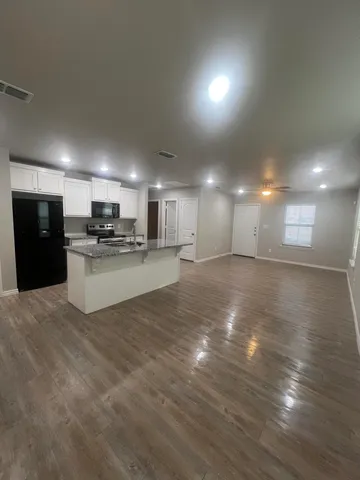 a view of kitchen with wooden floor