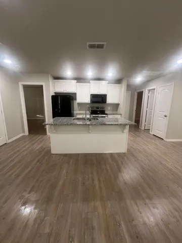 a view of kitchen with microwave refrigerator and microwave