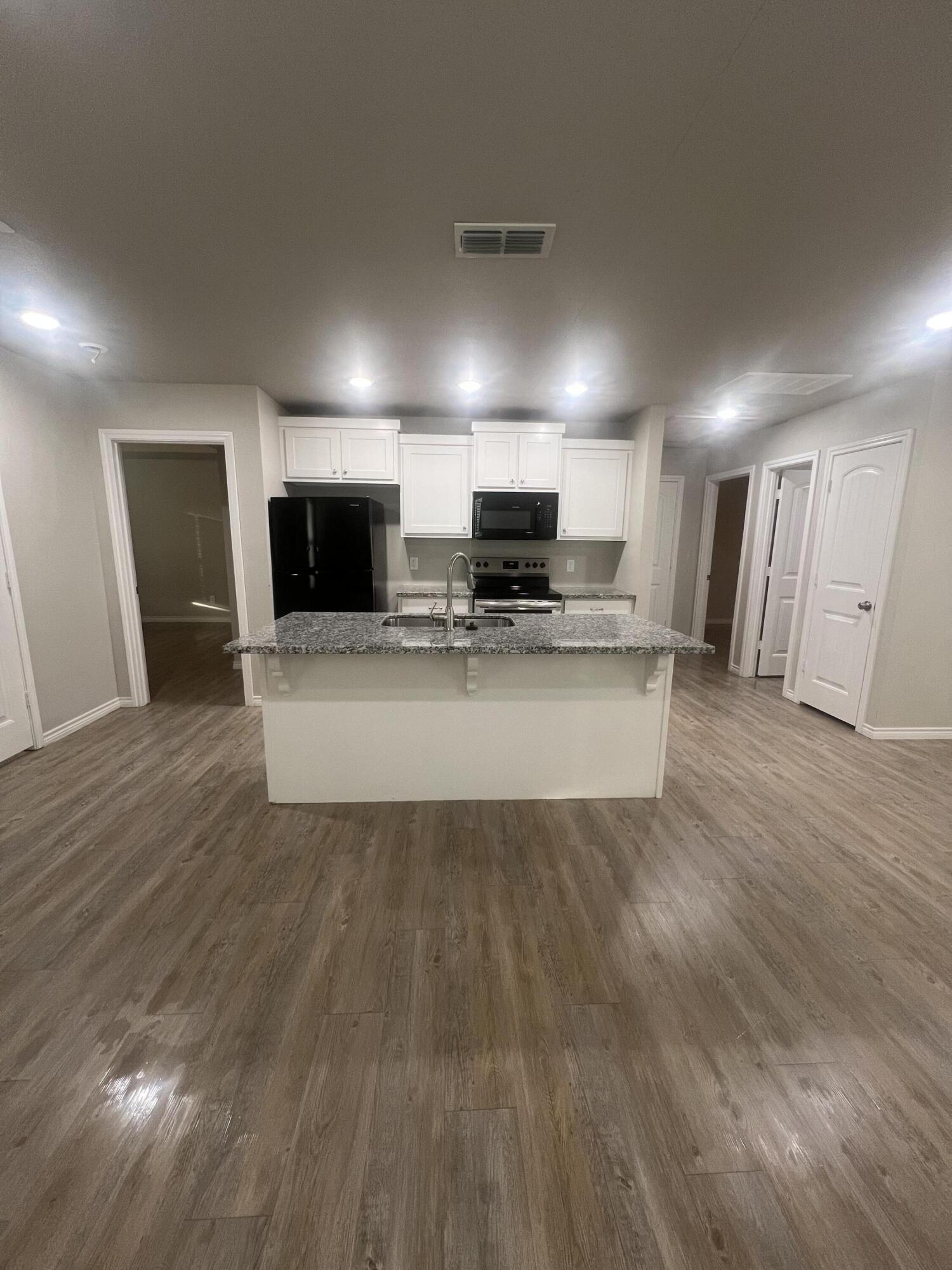 2632 Hickory Avenue Lubbock, TX 79404 - Photo 6 of 11 a view of kitchen with microwave refrigerator and microwave