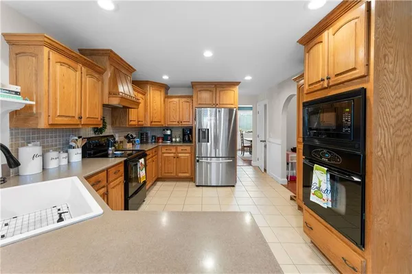 a kitchen with stainless steel appliances a refrigerator and a stove top oven