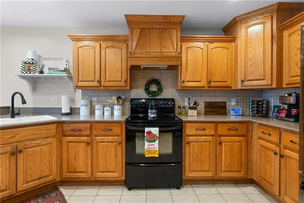 a kitchen with granite countertop a stove and cabinets