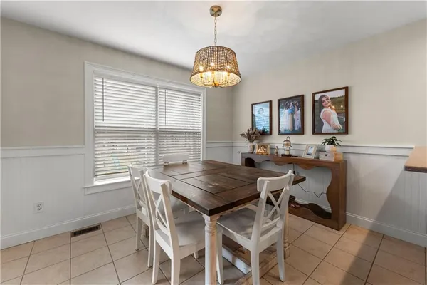 a view of a dining room with furniture and a chandelier