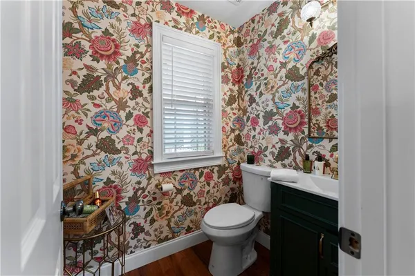 a bathroom with a toilet and a shower curtain