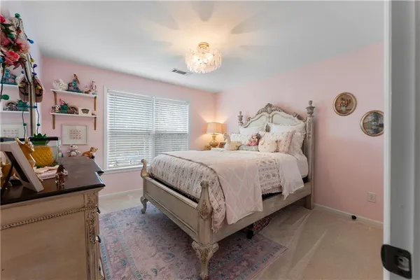 a bedroom with bed and a chandelier