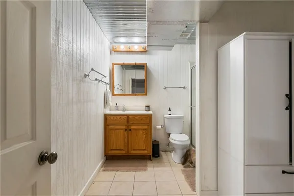 a bathroom with a granite countertop sink toilet and shower