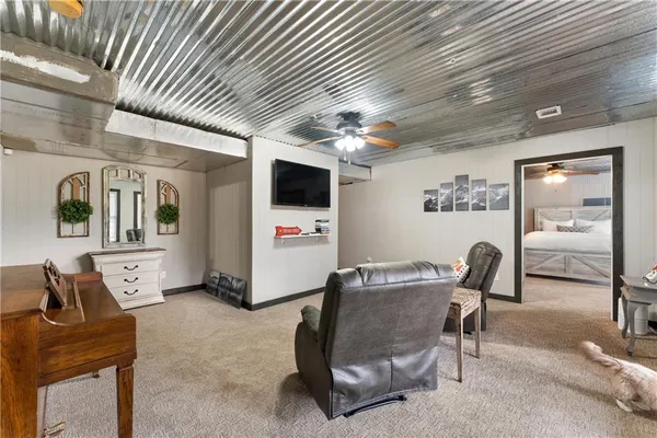a dining room with furniture and a flat screen tv