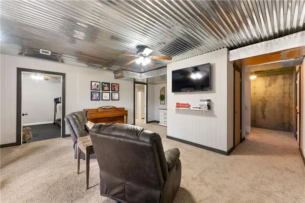 a view of a livingroom with furniture and a ceiling fan