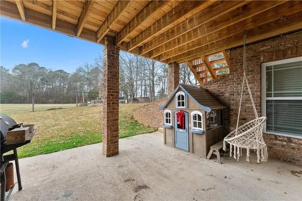a view of a porch with furniture and a gate
