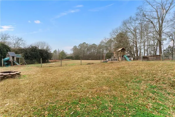 a view of open space with green field and trees
