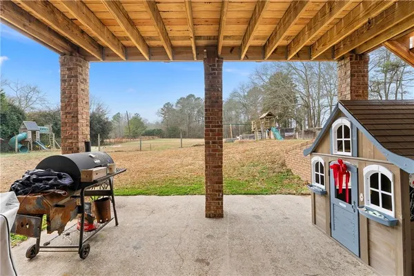 a view of a porch with furniture and a yard