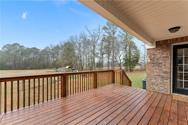 a view of balcony with wooden floor and fence