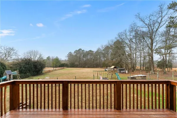 a balcony with wooden floor and fence