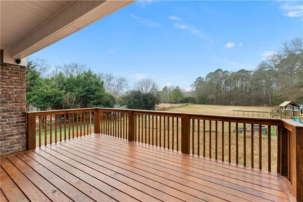 a balcony with wooden floor and fence