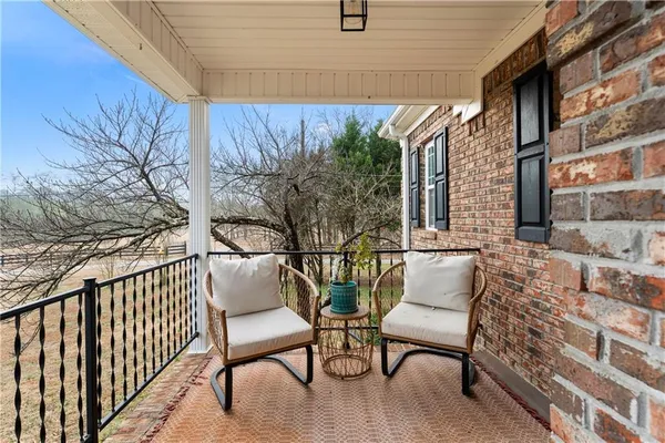 a view of a chairs and table in the balcony