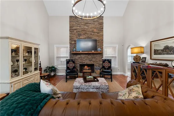 a living room with furniture a fireplace and a flat screen tv