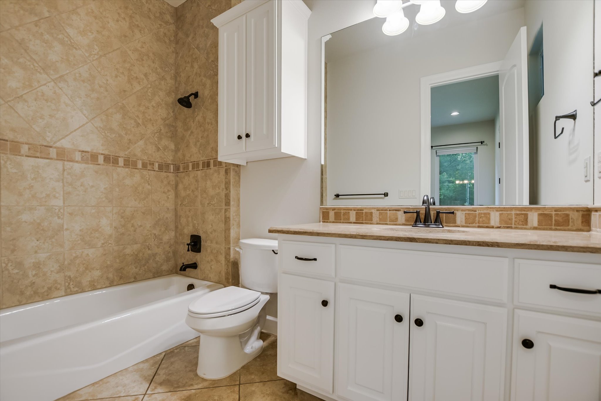 11 Inwood Circle Austin, TX 78746 - Photo 30 of 38 A well-appointed bathroom with a spacious vanity and integrated tub-shower combination.