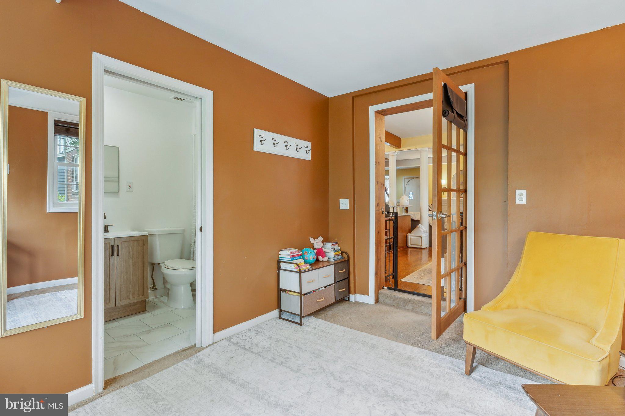 5207 Eugene Avenue Baltimore, MD 21206 - Photo 12 of 36 a bedroom with a bed and a view of bathroom