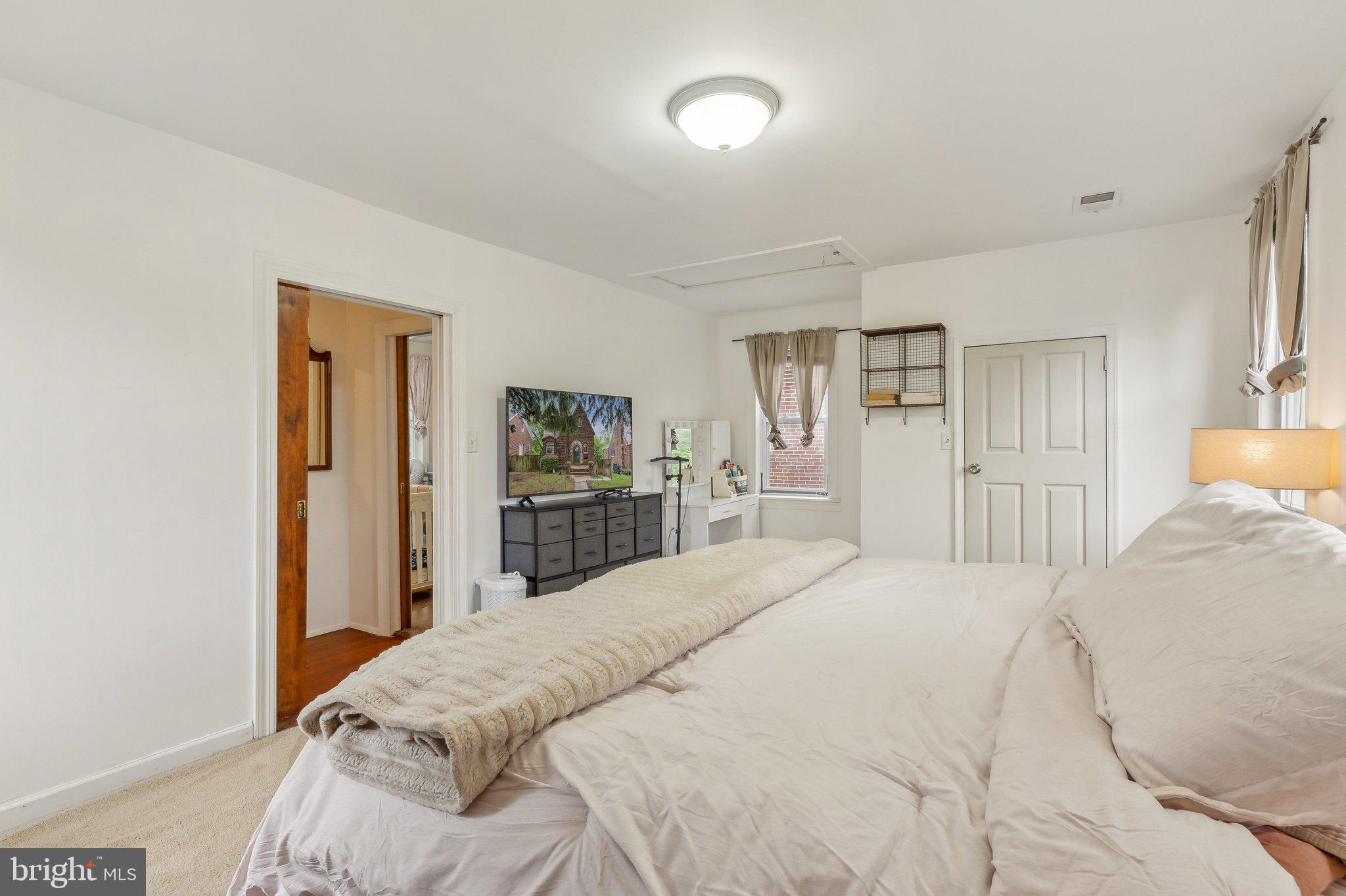 5207 Eugene Avenue Baltimore, MD 21206 - Photo 16 of 36 a bedroom with a large bed and a closet