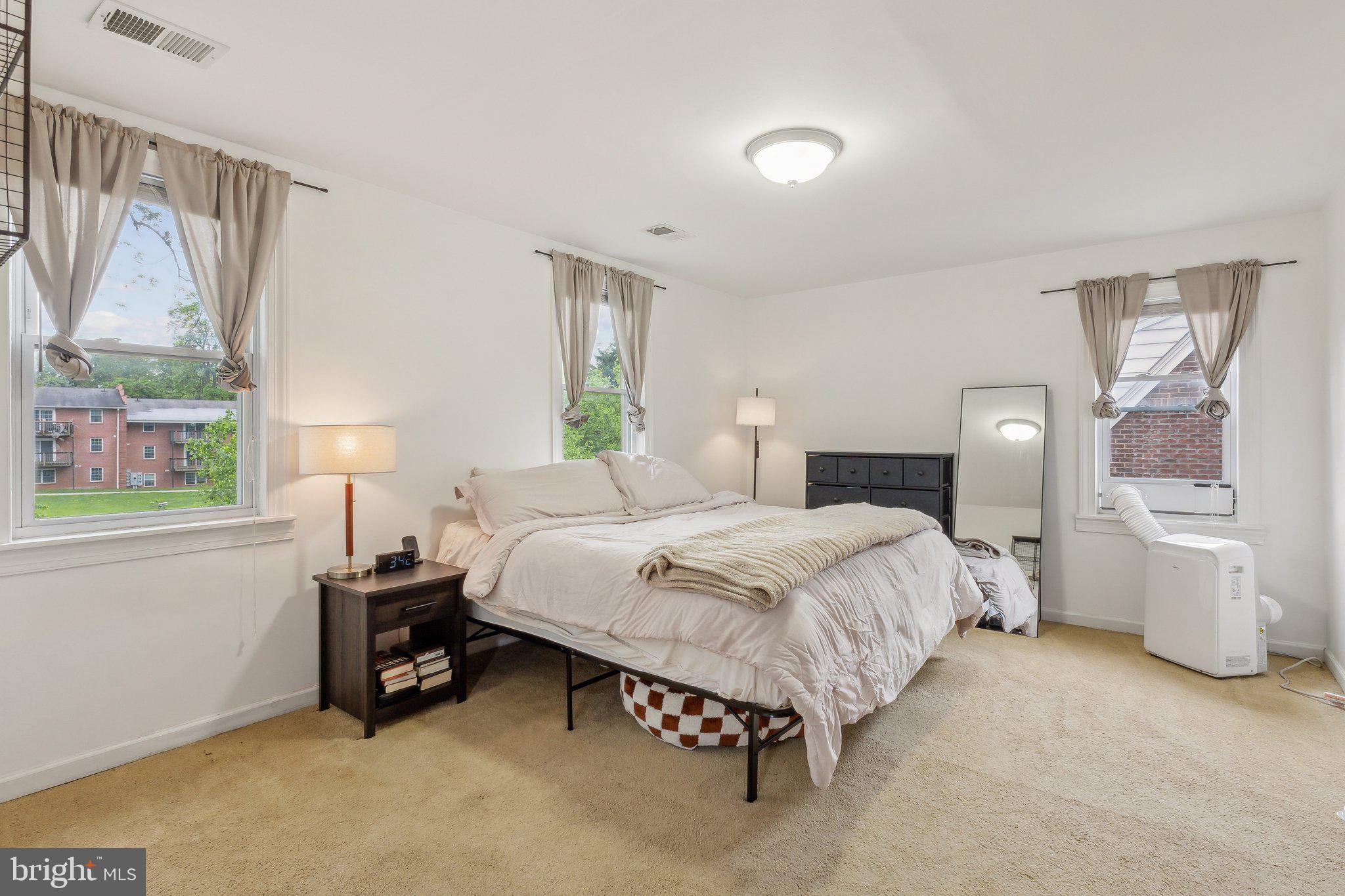 5207 Eugene Avenue Baltimore, MD 21206 - Photo 17 of 36 a bedroom with a bed and a window