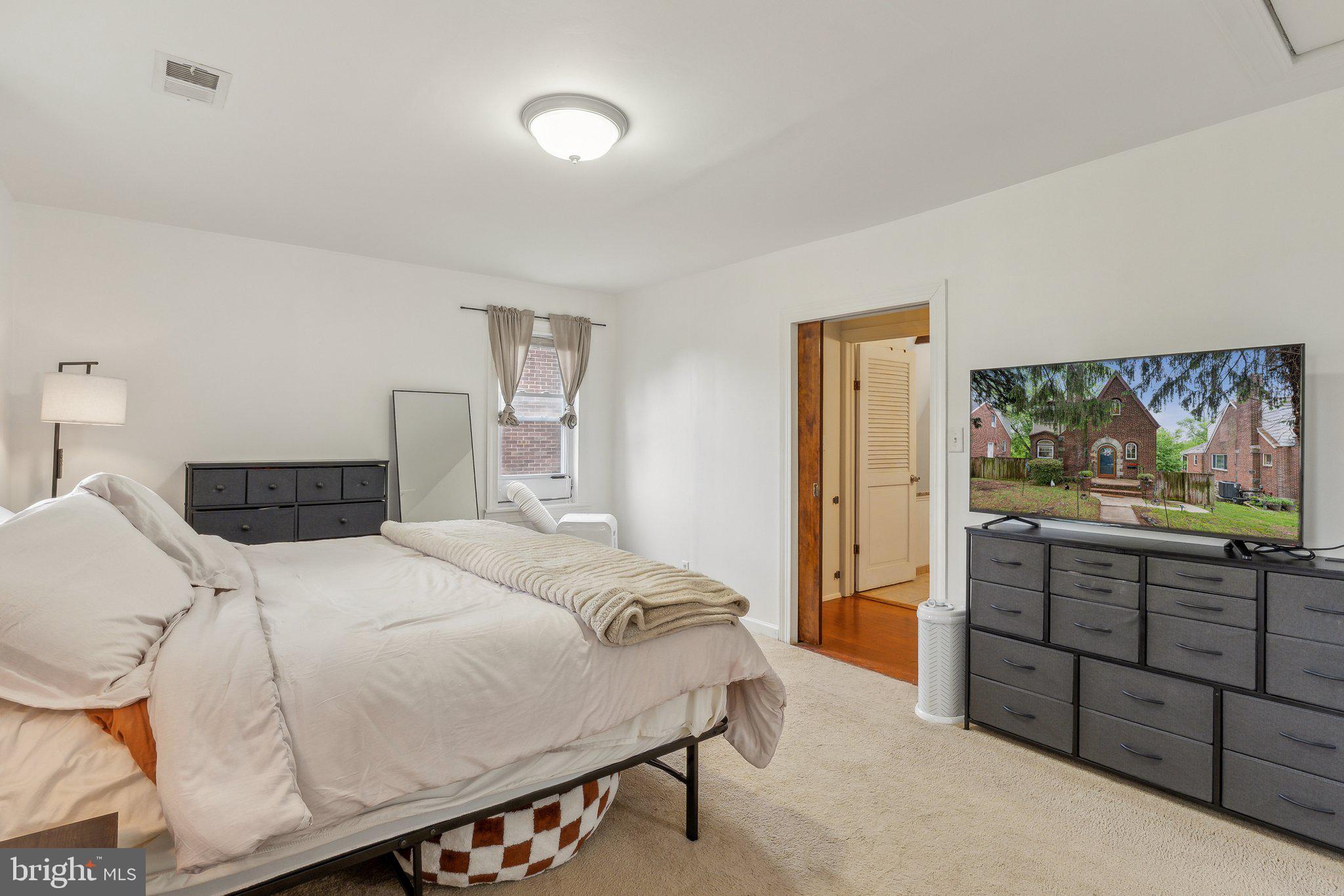 5207 Eugene Avenue Baltimore, MD 21206 - Photo 18 of 36 a bedroom with a bed and a dresser