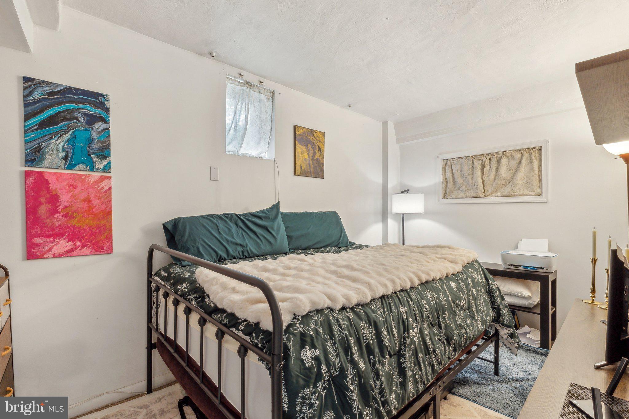 5207 Eugene Avenue Baltimore, MD 21206 - Photo 23 of 36 a bedroom with a bed and a painting on the wall