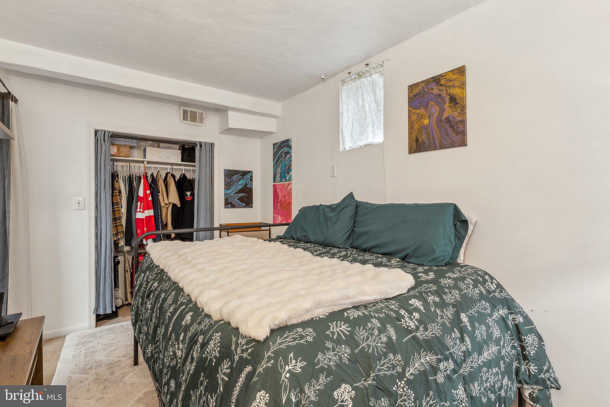 5207 Eugene Avenue Baltimore, MD 21206 - Photo 24 of 36 a bed sitting in a bedroom next to a window