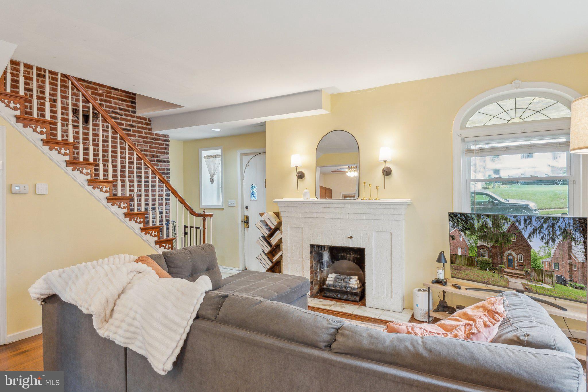 5207 Eugene Avenue Baltimore, MD 21206 - Photo 3 of 36 a living room with furniture a fireplace and a large window