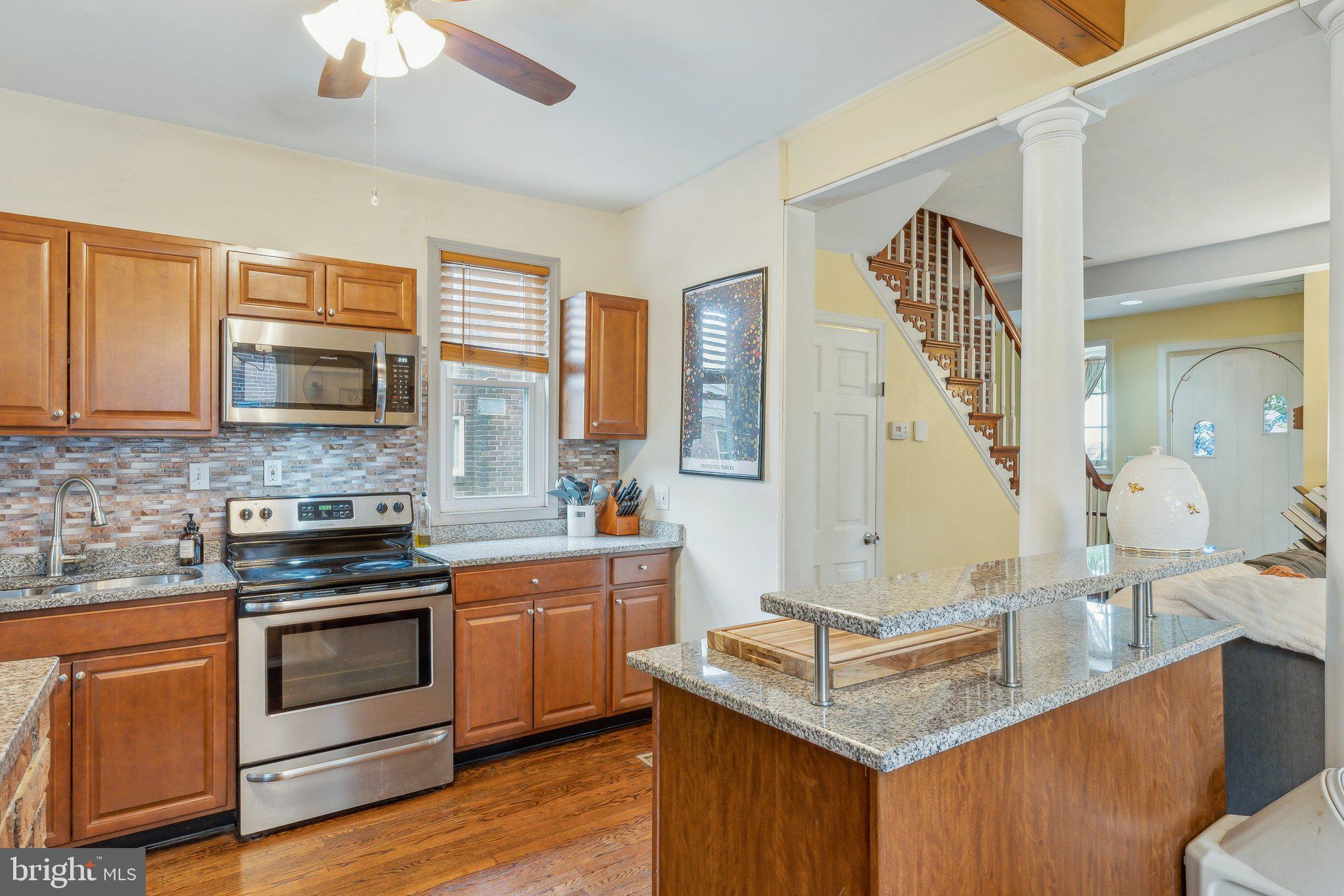 5207 Eugene Avenue Baltimore, MD 21206 - Photo 7 of 36 a kitchen with stainless steel appliances granite countertop a stove and a sink