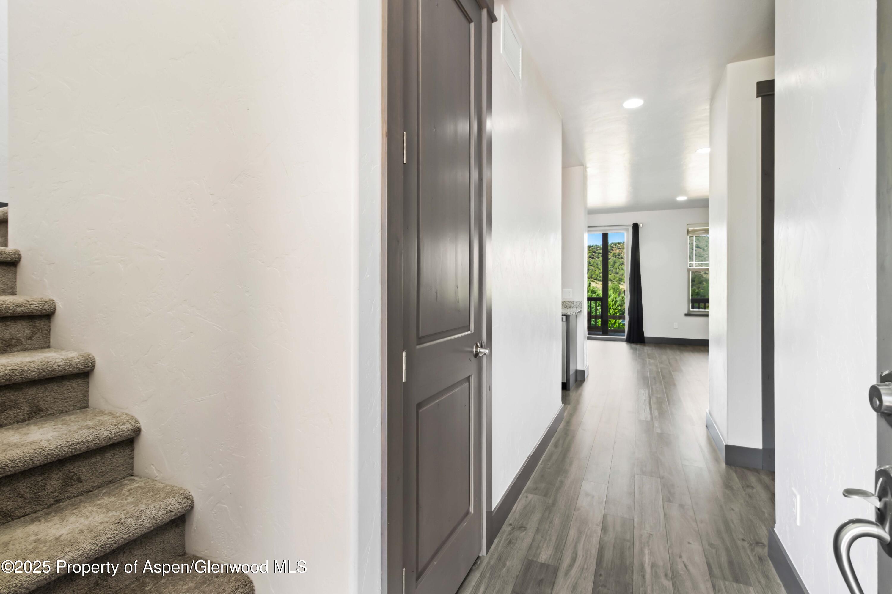123 Redstone Drive New Castle, CO 81647 - Photo 12 of 34 a view of a hallway with wooden floor