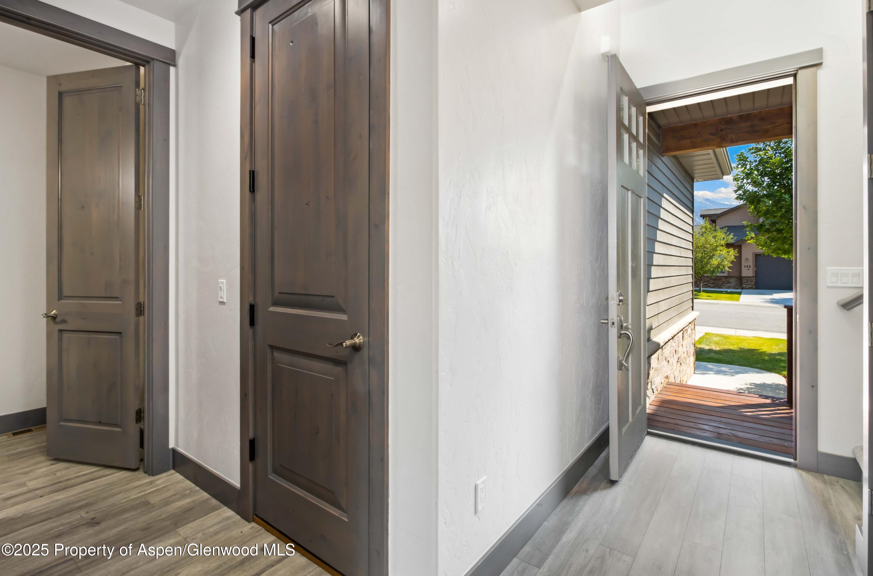 123 Redstone Drive New Castle, CO 81647 - Photo 13 of 34 a view of a hallway with wooden floor and a bedroom