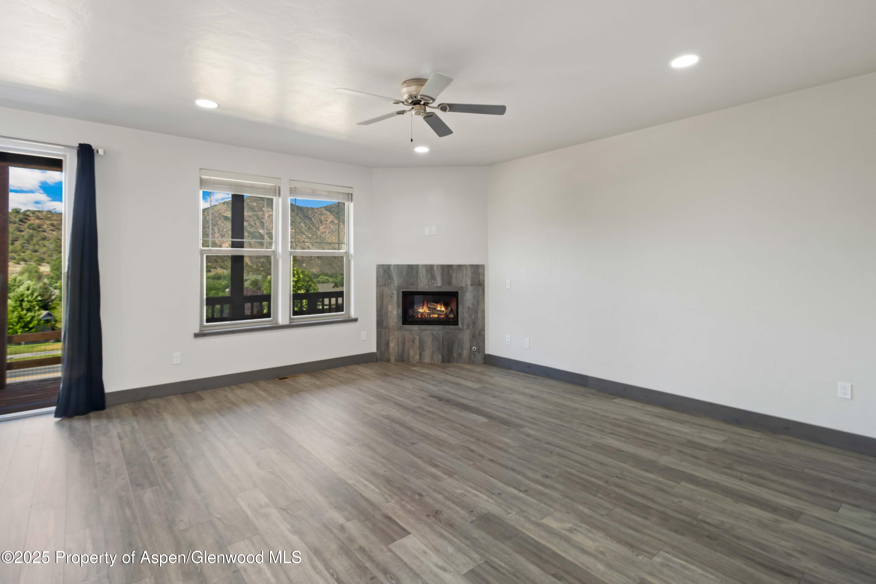 123 Redstone Drive New Castle, CO 81647 - Photo 15 of 34 wooden floor in an empty room with a window