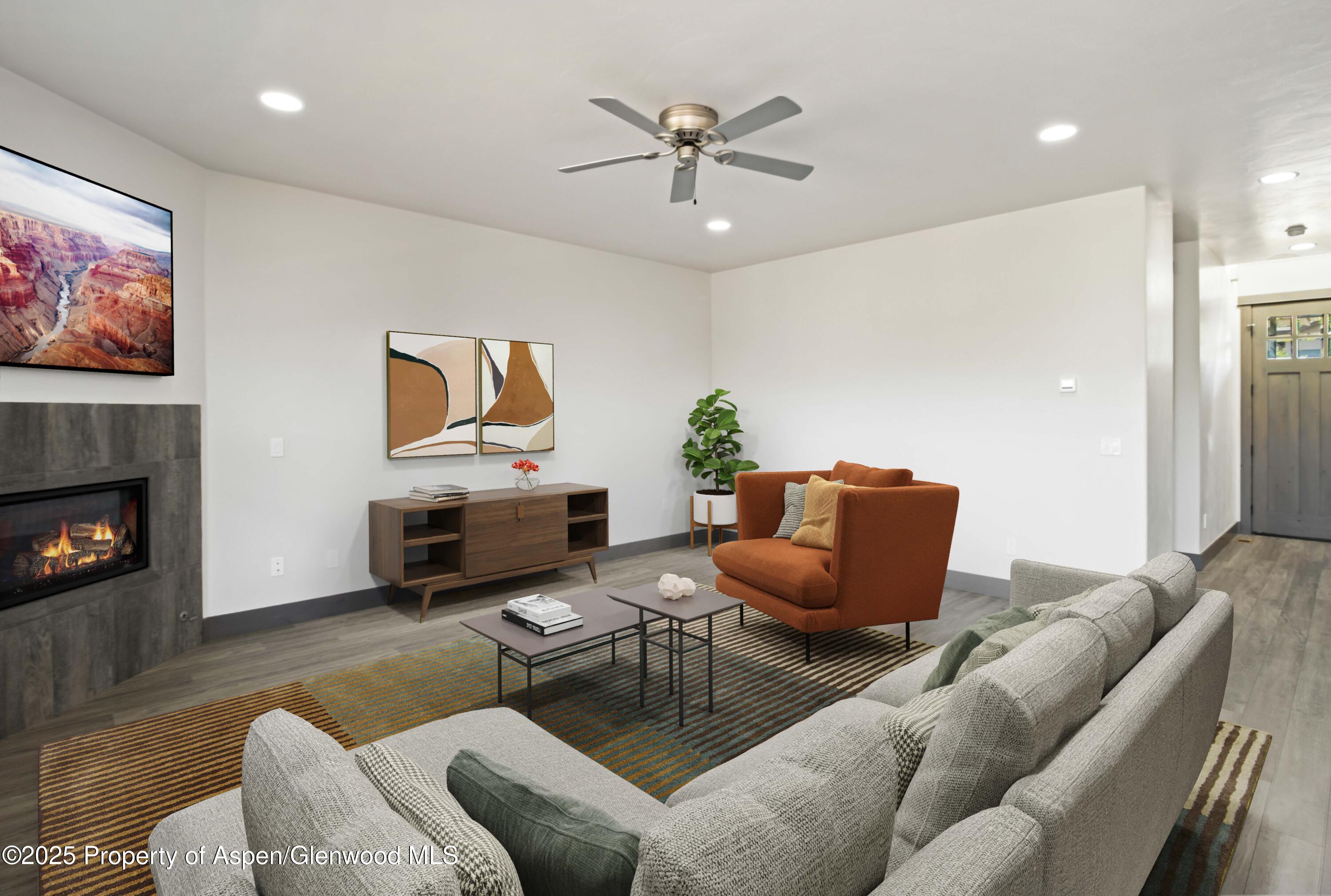 123 Redstone Drive New Castle, CO 81647 - Photo 16 of 34 a living room with furniture a fireplace and a flat screen tv